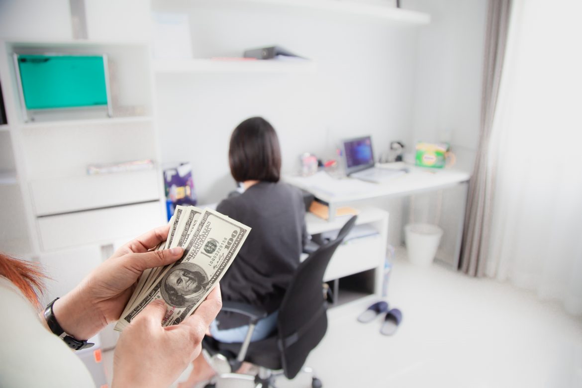 Woman counting money from side business