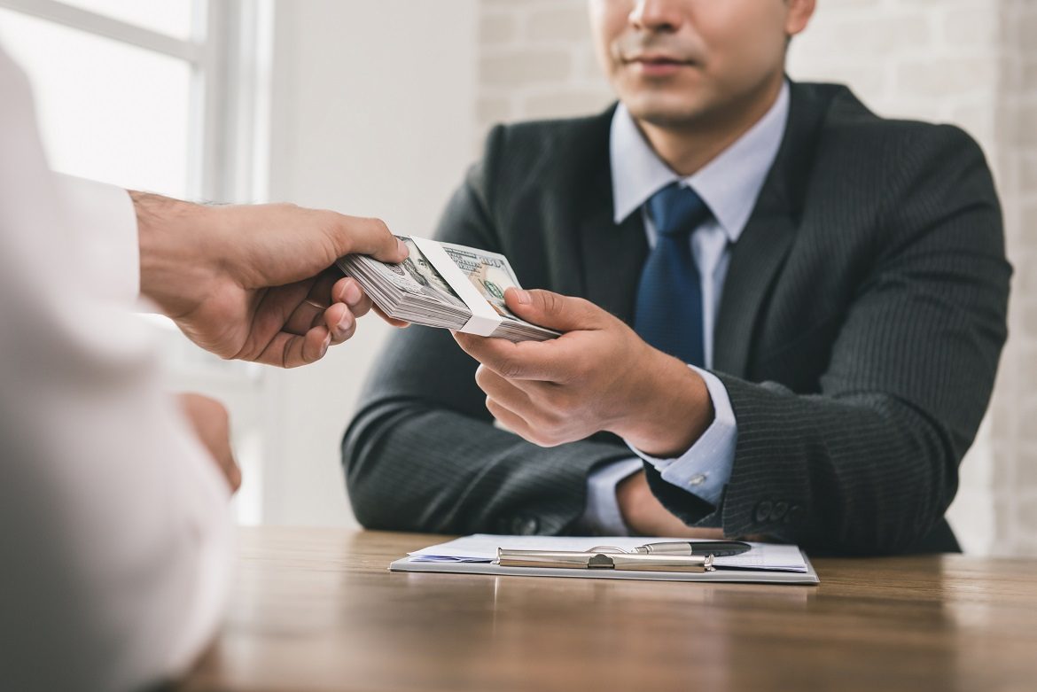 Businessman receiving money after contract signing