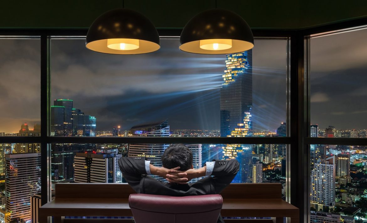 Millionaire businessman admiring the view of his success